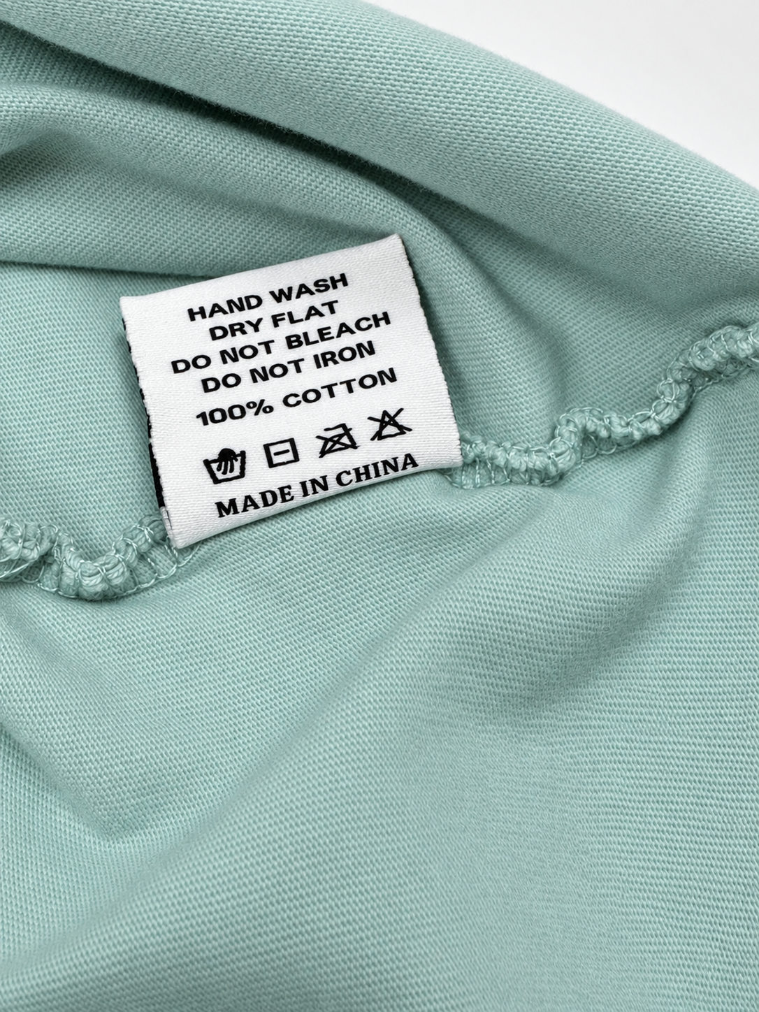 Close-up view of printed graphic detail on mint Bruce Lee T-shirt