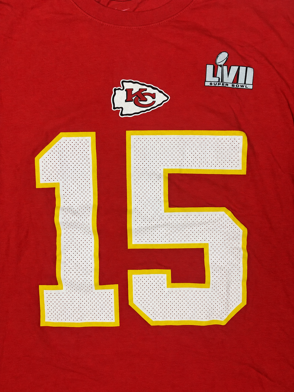 Close-up view of Chiefs arrowhead and Super Bowl LVII graphics on red Nike T-shirt