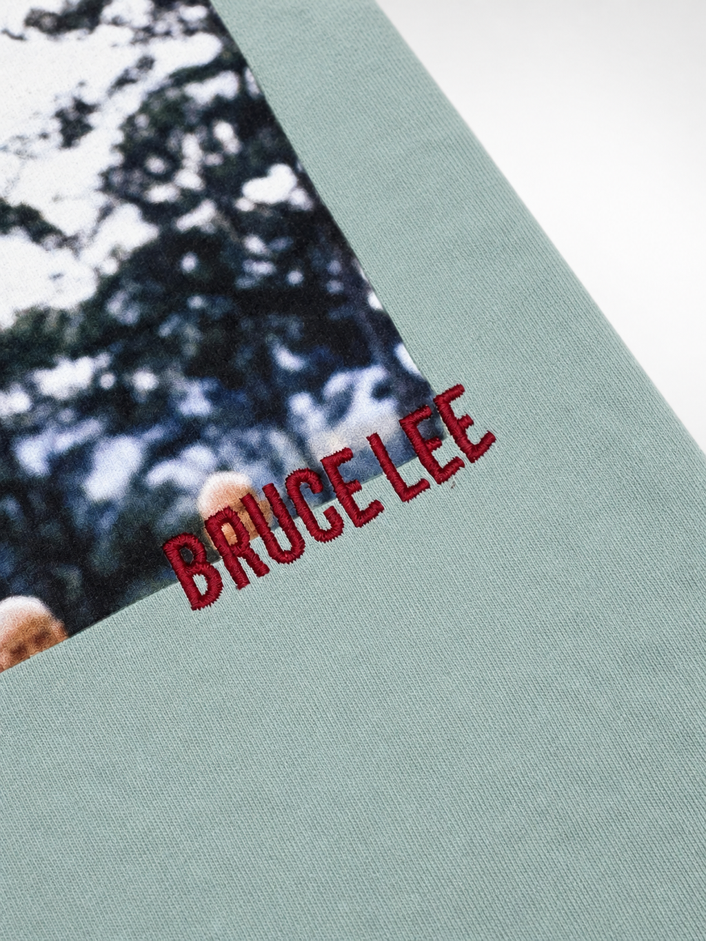 Back view of mint Bruce Lee x Shoe Palace T-shirt with photo and red embroidered graphics