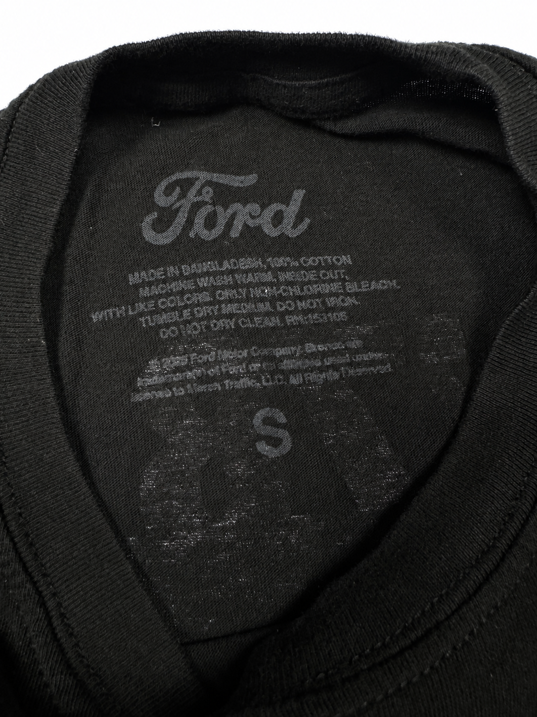 Ford neck label showing Small and 100 percent cotton inside black T-shirt