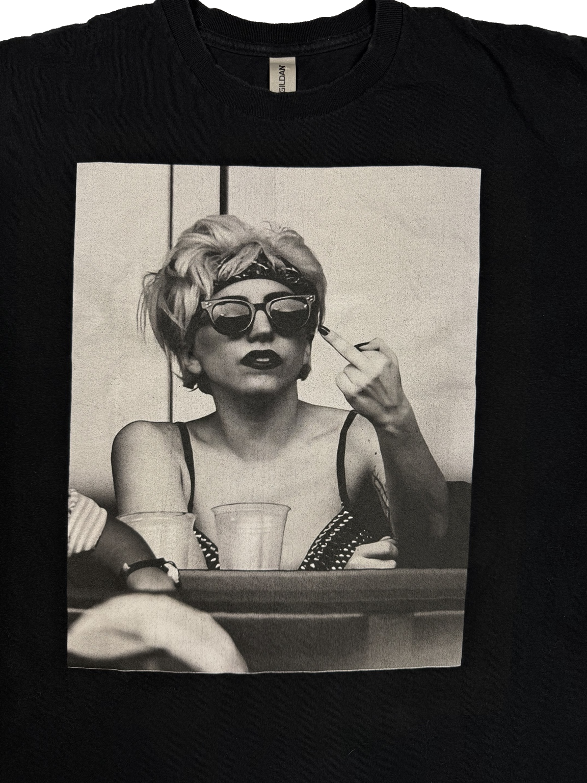 Close-up view of Lady Gaga black-and-white photo graphic on black Gildan T-shirt