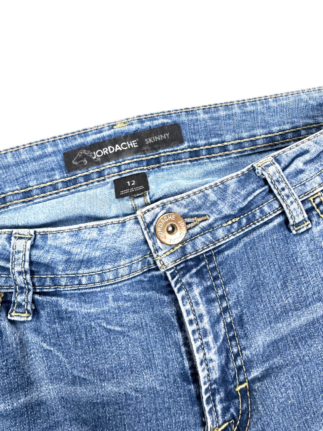 Close-up of rose embroidery on Jordache blue jeans