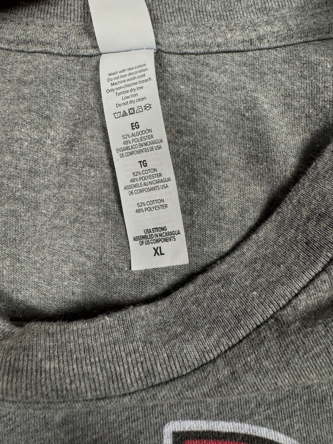 Care label showing 52 percent cotton and 48 percent polyester inside heather-gray T-shirt