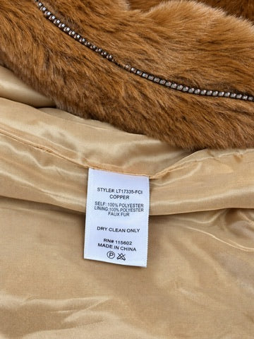 LUSH jacket care label showing copper color, 100% polyester shell and lining, faux fur, and dry clean only instructions.