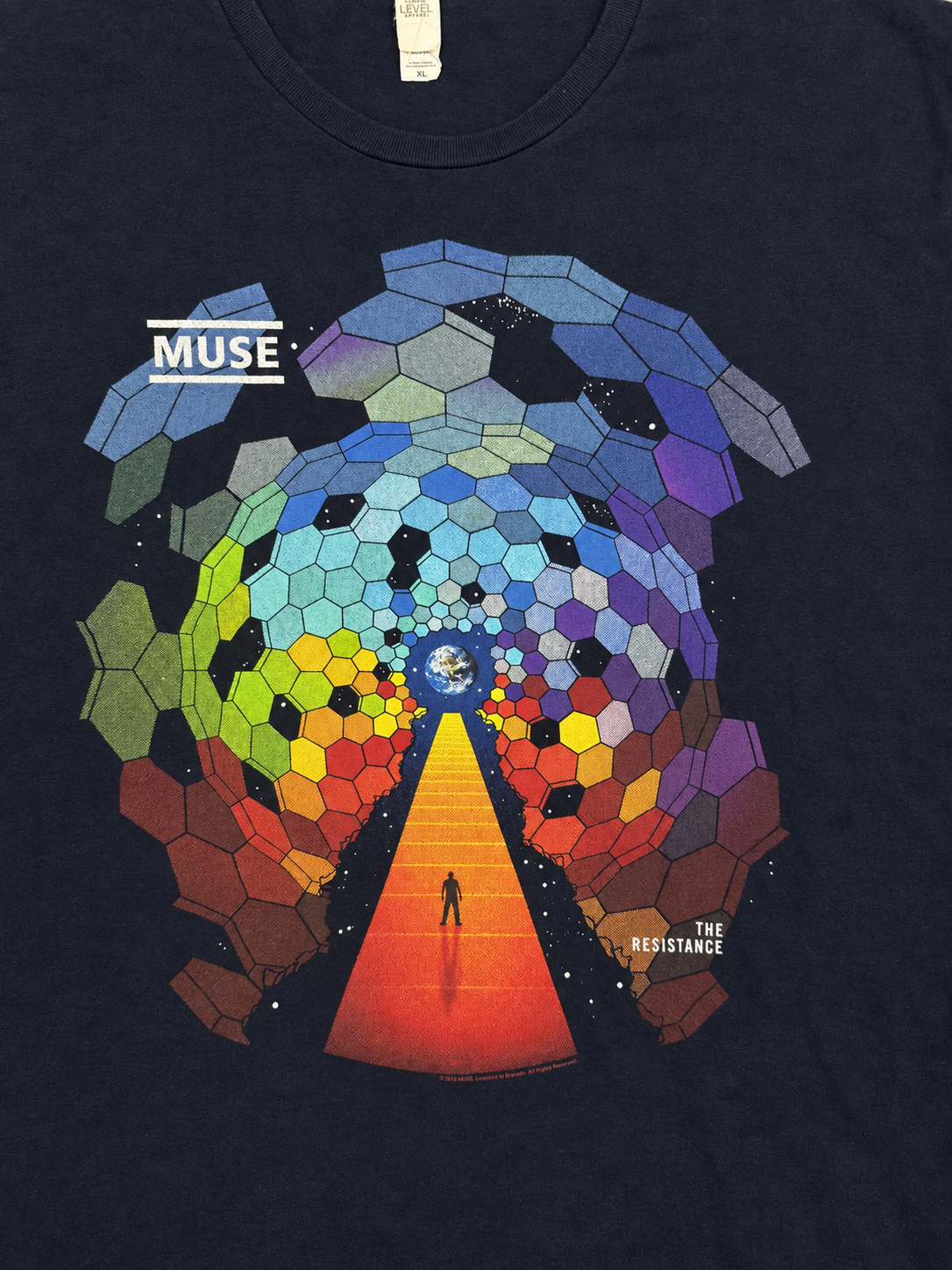 Close-up of Muse The Resistance front graphic with rainbow hexagons, Earth and a figure on an orange pathway