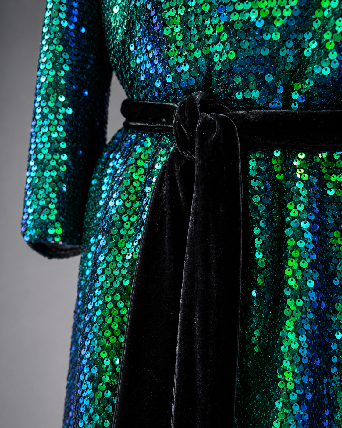 Iridescent green blue sequins and black velvet belt close up
