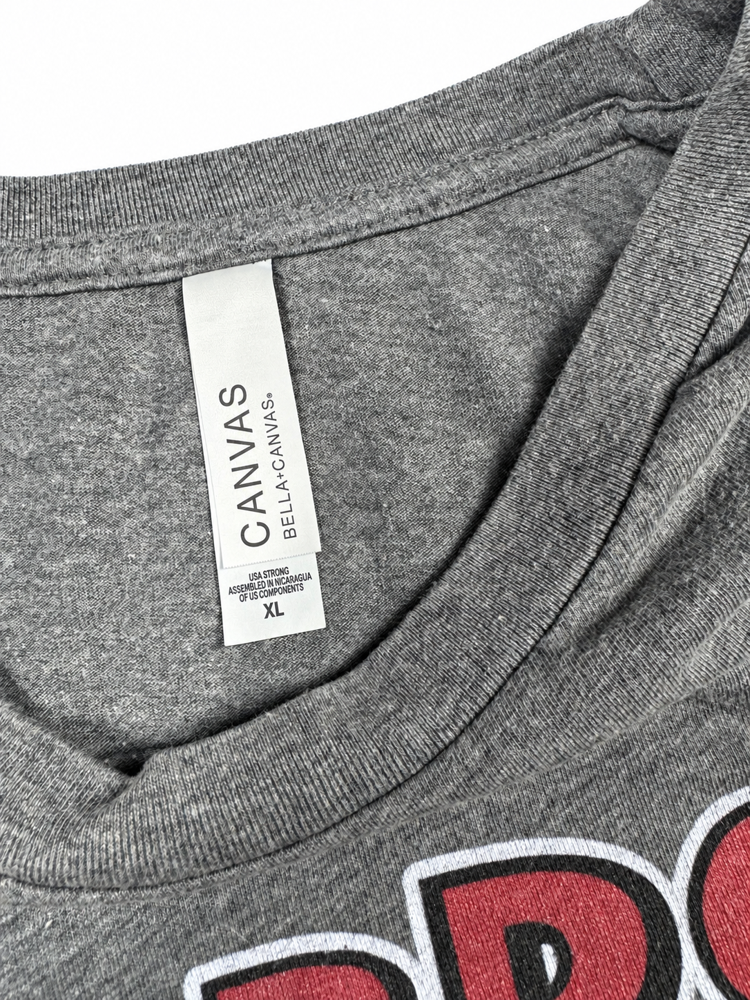 Bella+Canvas neck label showing XL on heather-gray graphic T-shirt