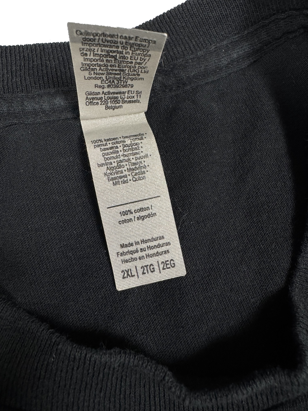 Fabric label showing 100 percent cotton inside black Lady Gaga T-shirt