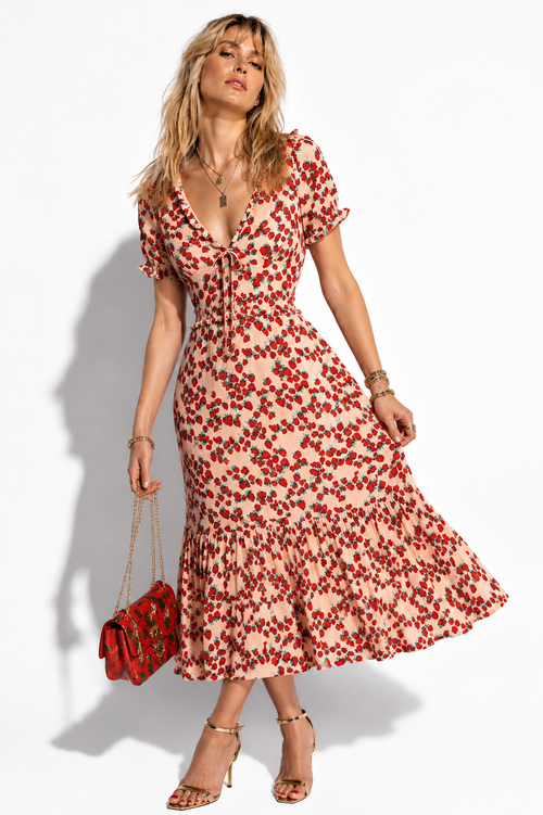 Model wearing Betsey Johnson blush strawberry print tiered midi dress