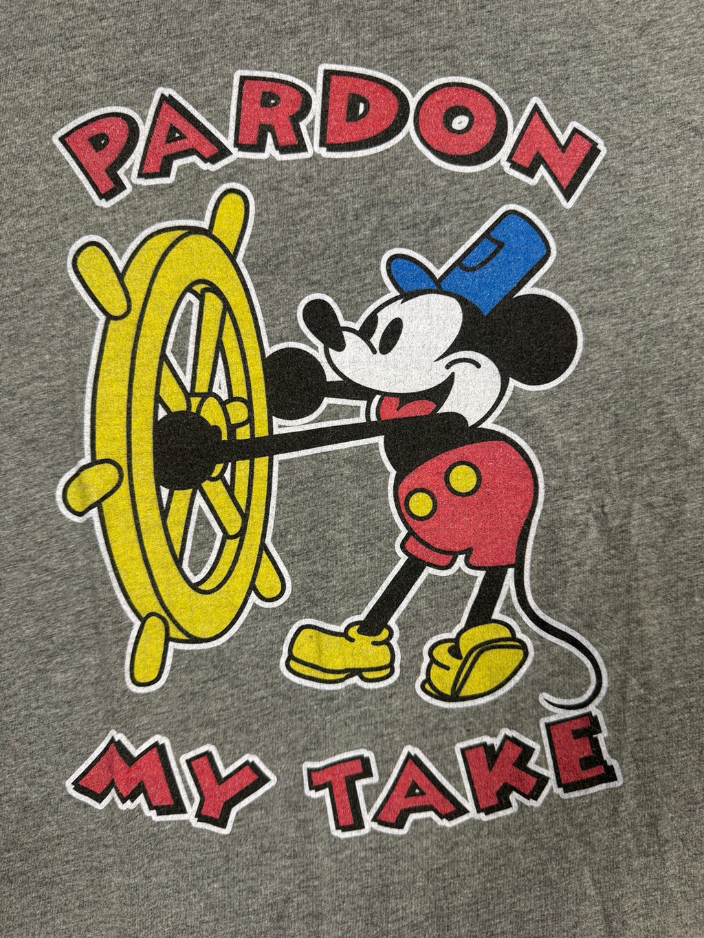 Close-up view of colorful Mickey ship-wheel graphic on heather-gray Bella+Canvas T-shirt