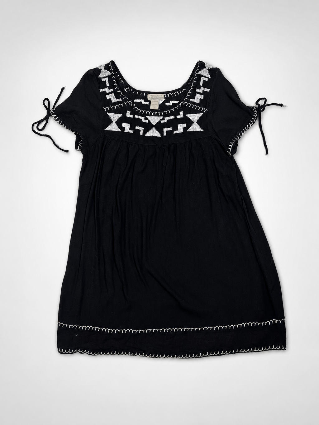 Close-up of white geometric embroidery on World Market black rayon dress