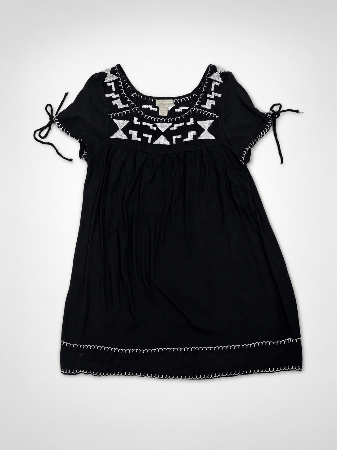 Close-up of white geometric embroidery on World Market black rayon dress