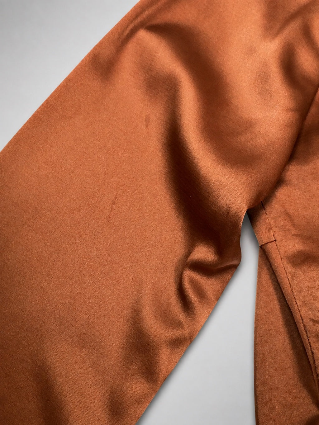 Close up of stain on copper satin romper
