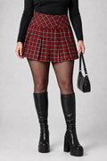 American Eagle red plaid pleated mini skirt styled on model with tights and boots